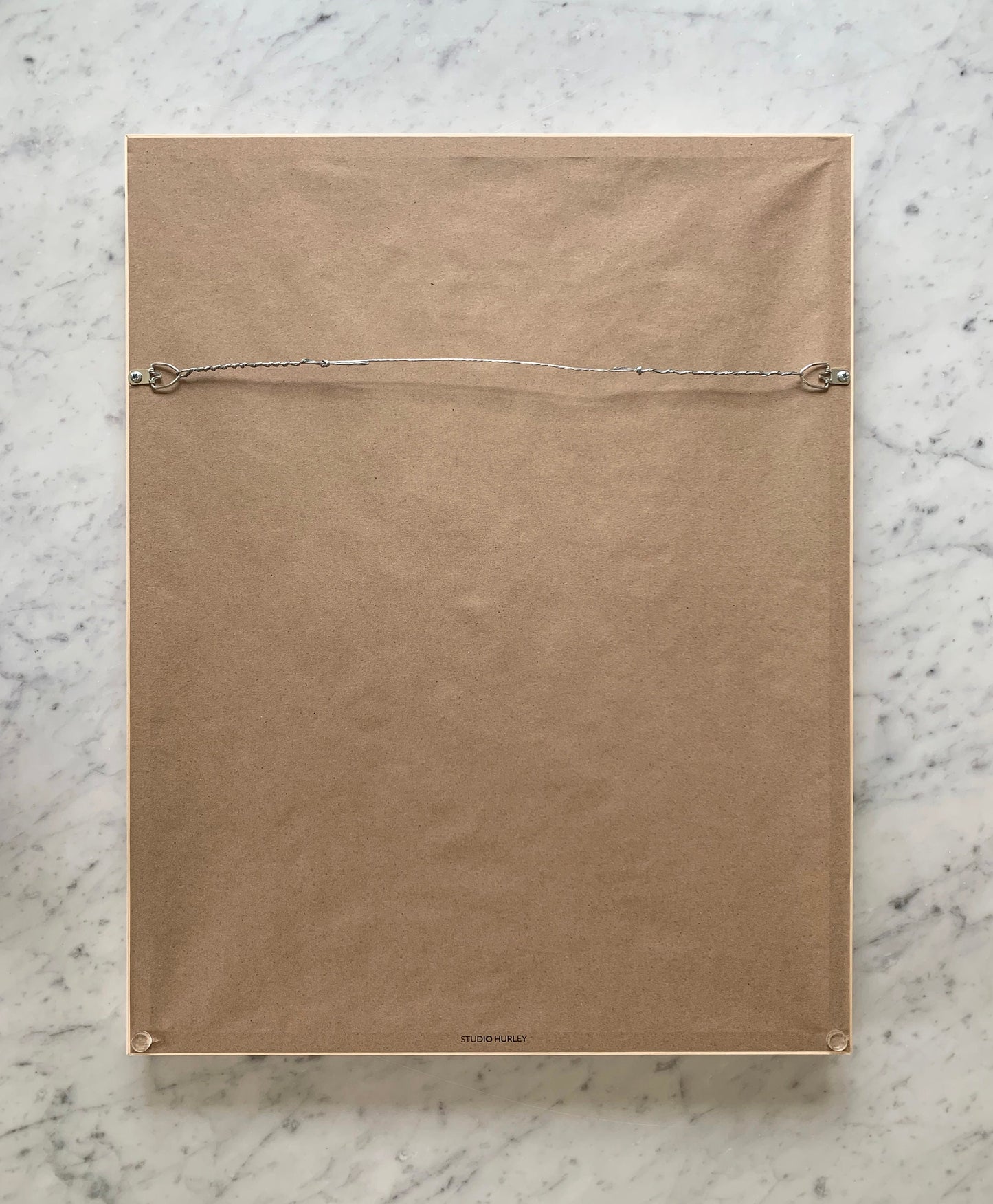 the back of a framed, ready to hang print by artist jorey hurley.  the frame includes a wire across the back for hanging and a kraft paper dust backing to protect the art. felt bumpers are on the bottom corners to protect the wall.